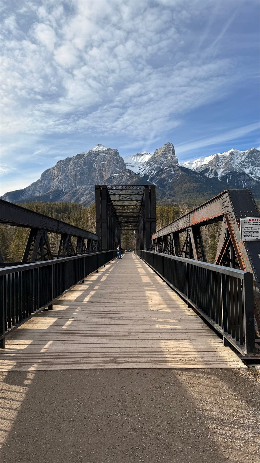 A bridge leading toward the Rocky Mountains near Canmore